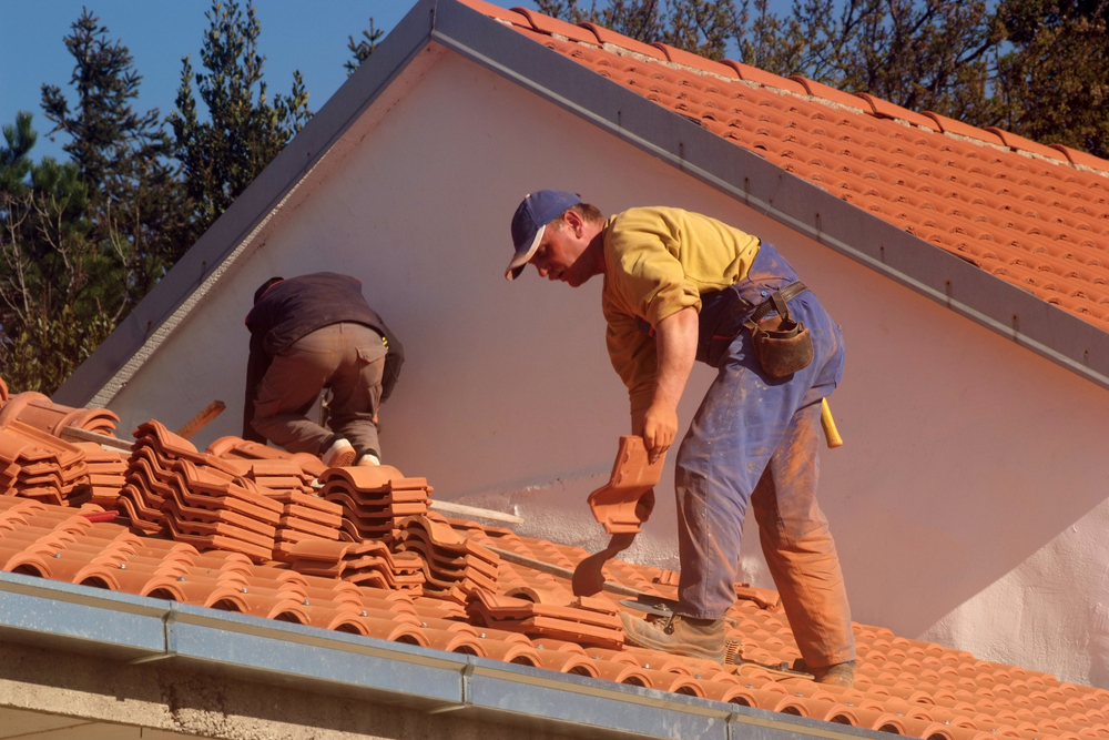 Spanish tile roofing at work