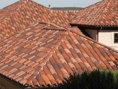 Close up of a residential roof with orange Boral clay tiles