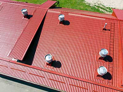Top view of a red metal roofing system on a commercial building